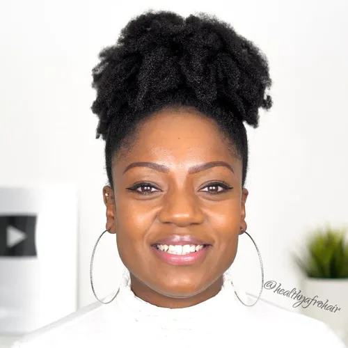 Try on this beautiful updo with a curly texture styled at the top