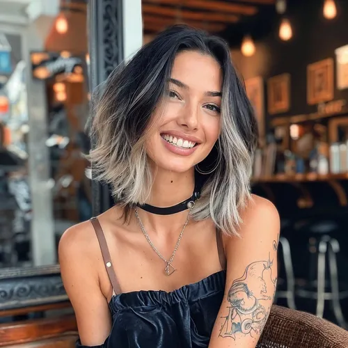 Try on an ombre bob hairstyle, featuring dark roots that seamlessly transition into a lighter shade towards the tips, styled in a casual, lightly tousled way.