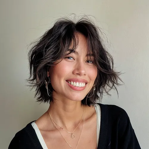 Try on this trendy messy bob hairstyle with soft waves, adding a playful and texturized look, perfect for a casual yet stylish appearance.