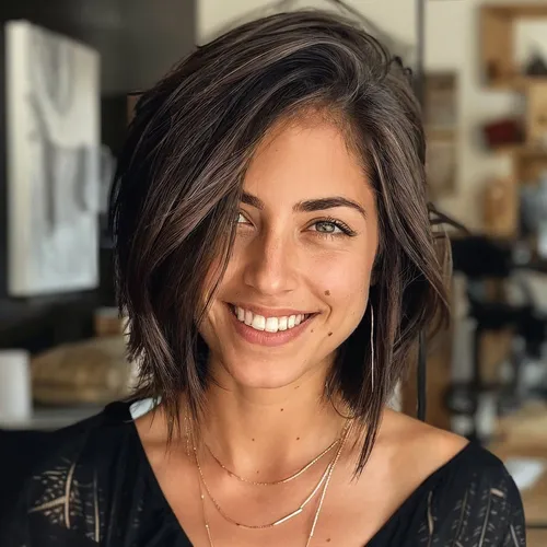 Try on this chic layered bob hairstyle, featuring short layers with textured waves adding volume and movement. The flows are parted to one side, enhancing the dynamic appearance.