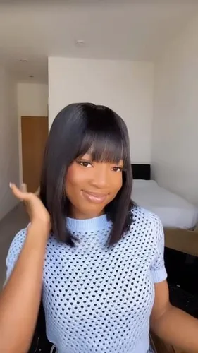 Try on this chic straight hairstyle complemented by neat bangs, giving a sleek and modern look.