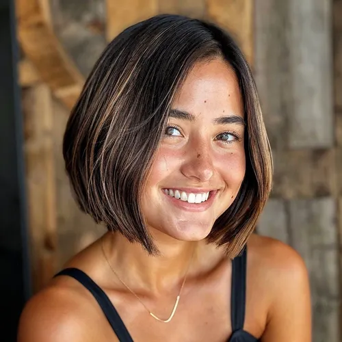 Try on a stylish bob cut with brown and blonde highlights, ideal for a fresh and modern look.