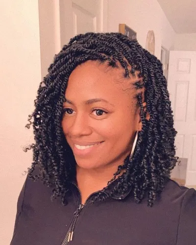 Try on this hairstyle, featuring tightly coiled twist braids that frame the face elegantly. The hairstyle enhances a cheerful expression with each braid neatly twisted and cascading down.