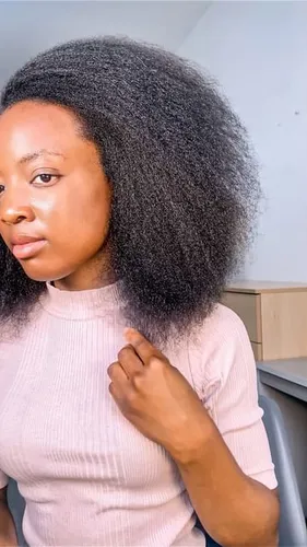 Try on this voluminous afro hairstyle that features thick, textured hair.