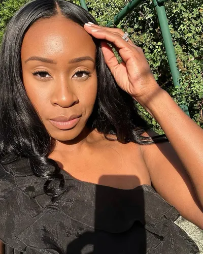 Try on a long, straight hairstyle with a neat center parting, as seen here. The hairstyle is styled smooth and sleek, elegantly framing the face.