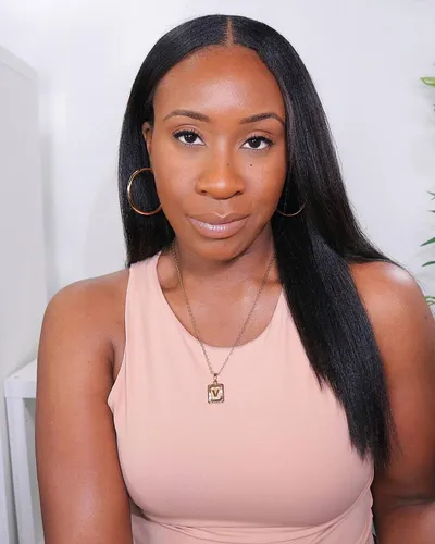 Try on this straight hairstyle where the hair is sleek and flows past the shoulders with a slight inward curve at the ends, presenting an elegant and polished look.