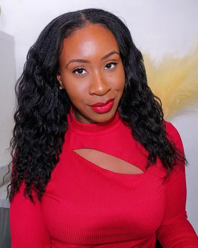 Try on this long wavy hairstyle featuring voluminous, dark curls that flow gracefully down the shoulders.