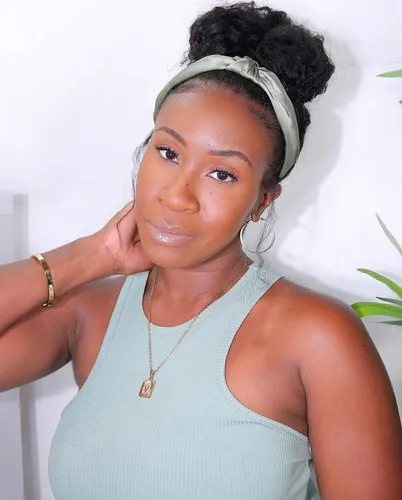 Try on a hairstyle featuring a high bun wrapped with a light green headband, suitable for a neat and stylish look.