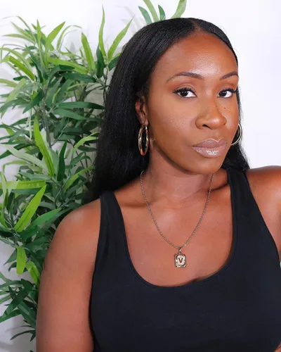 Try on this sleek straight hairstyle showcased by the person in the image. The hair is styled in a long, flowing, straight manner complementing her elegant look.