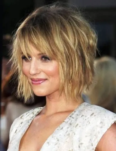 Try on this shaggy bob hairstyle, featuring textured layers that provide a casual yet chic look, perfect for versatile styling.