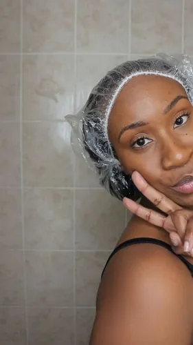 Try on a hairstyle with the hair covered by a plastic shower cap, typically worn to protect the hair during a shower or hair treatment process.