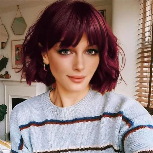 Try on a short, wavy, burgundy hairstyle presented in an indoor setting. The hair elegantly frames the neckline.