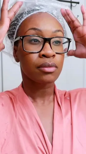 Try on a covered hairstyle with a plastic cap, presumably for a hair treatment process.