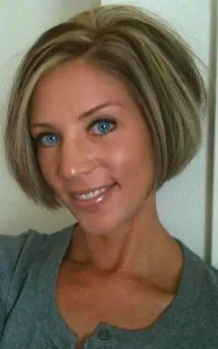 Try on this angled bob cut hairstyle, featuring sleek straight strands around the face and a neat side parting that adds symmetry to the look.