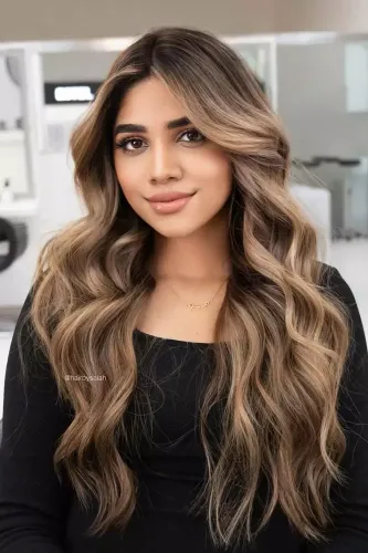 Try on this long, wavy ombre hairstyle with soft curls blending from dark roots to light tips