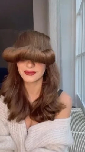 Try on this unique combo hairstyle featuring a mushroom haircut covering the eyes paired with long, wavy locks flowing beneath.