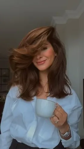 Try on this tousled, medium-length wavy hairstyle, which flares gently around the shoulders.
