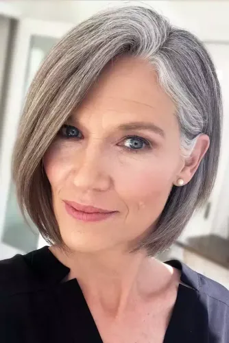 Try on this sleek bob cut hairstyle that's elegantly styled with natural gray tones.