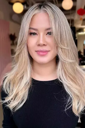 Try on this beautiful long, wavy, blonde hairstyle that frames the face elegantly, enhancing any look with its soft, flowing waves.
