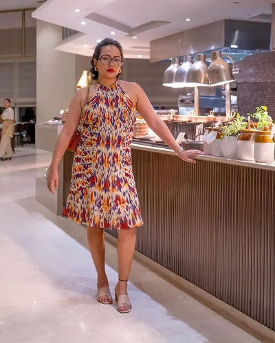 Try on a neat, high bun hairstyle paired with glasses, perfect for an elegant evening out.