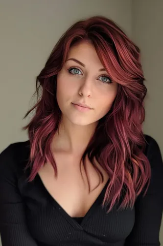 Try on this wavy red hairstyle that features rich crimson and burgundy tones, styled in textured waves for a voluminous look.
