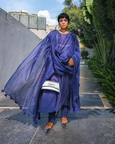 Try on a short straight bob haircut, featuring a neatly styled hairdo that complements the person's poised appearance.