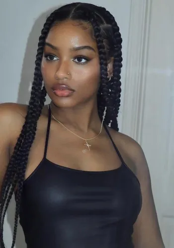 Try on a hairstyle featuring medium-sized, neatly styled box braids cascading down the sides.