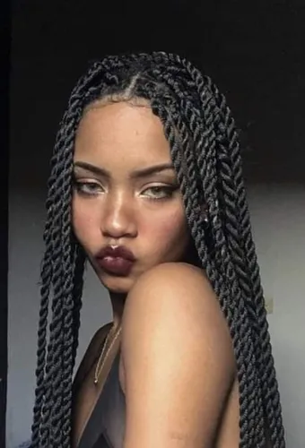 Try on this hairstyle featuring long braided twists that elegantly frame the face, providing a stunning and intricate look.