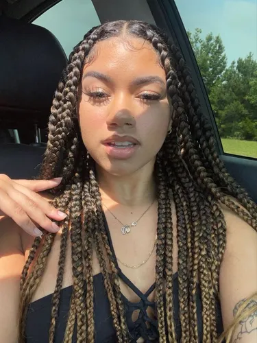 Try on this detailed hairstyle featuring numerous thin box braids intertwined with highlights, each tightly woven to offer a structured yet stylish look.