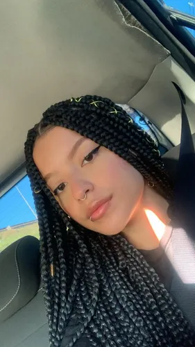 Try on the hairstyle of box braids that are long and intricately styled, providing a detailed and textured look.