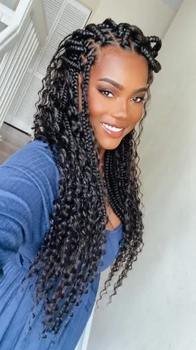 Try on this long, curly and braided hairstyle that features a stylish mix of tighter braids at the roots that transition into loose curls.