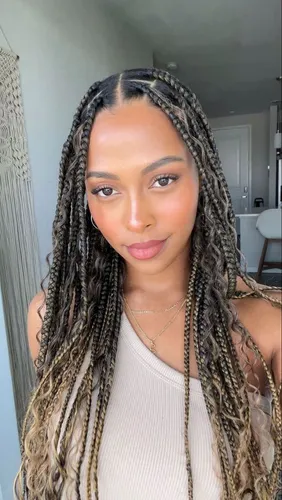 Try on this hairstyle featuring long, intricately braided hair with highlights of blonde and brown tones.