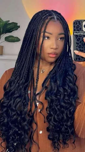 Try on this hairstyle featuring long braids with curly ends, providing a captivating mix of textures.