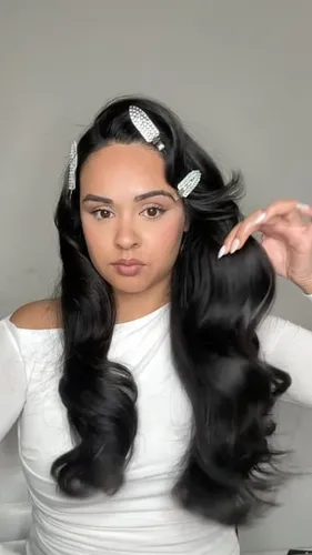 Try on this elegant long wavy hairstyle accentuated with sparkling hair accessories.