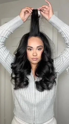 Try on this long wavy hairstyle featuring luxurious dark curls cascading down