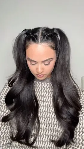 Try on a hairstyle featuring long, wavy hair partially held up with sectioned strands at the crown, some pulled back from the forehead.