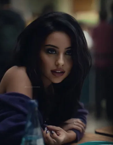 Try on this long, wavy hairstyle that cascades elegantly around the face, highlighting a modern and polished look.