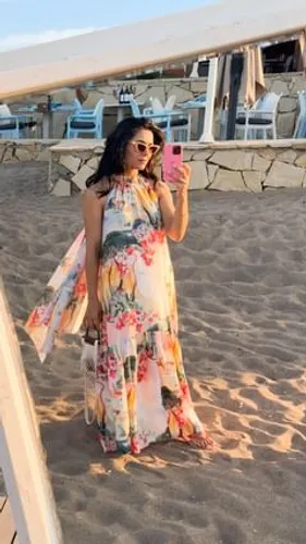 Try on a beachside style with curly hair complementing a floral dress.