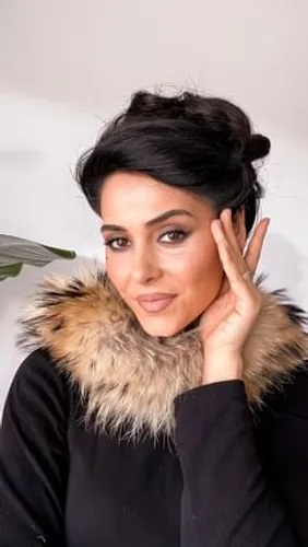 Try on a sleek updo hairstyle, featuring neatly gathered hair at the back, creating an elegant bun on top.