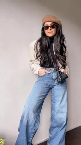 Try on this hairstyle featuring long, wavy black hair under a beige hat, complementing a chic style.