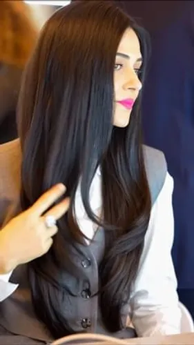 Try on a long, straight black hairstyle that falls smoothly down the shoulders