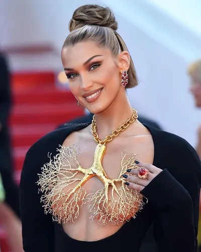 Try on this sleek high bun hairstyle, styled neatly atop the head for a chic and elegant look.