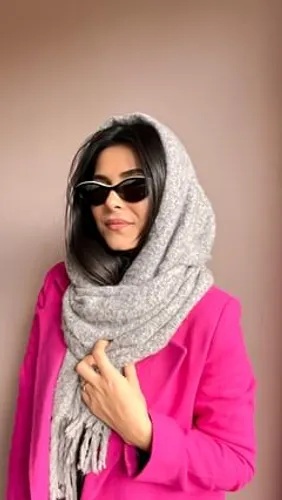 Try on a sleek long hairstyle under a cozy grey scarf, for a stylish winter look.