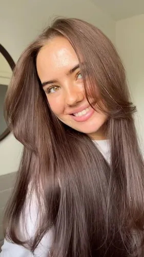 Try on this long, straight brown hairstyle, capturing a radiant appearance with naturally voluminous hair