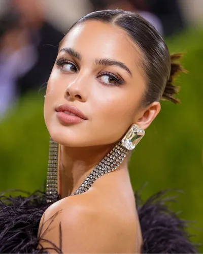 Try on a sophisticated slicked-back hairstyle with a neat, short bun element, ideal for a polished and refined appearance.