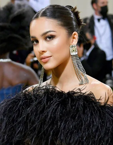 Try on a sophisticated slicked-back bun hairstyle that complements a formal or fashionable attire.