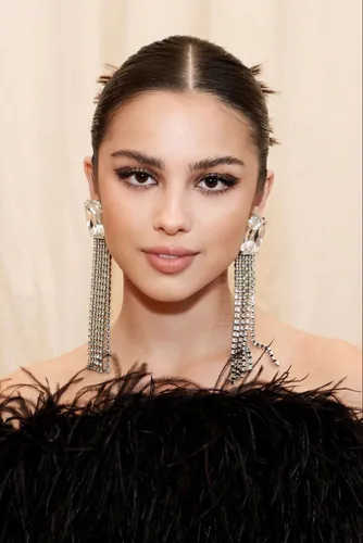 Try on this slicked-back hairstyle with a neat center part, demonstrating a sophisticated and polished look.