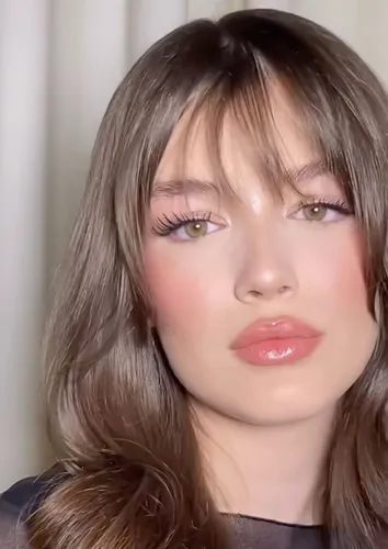 Try on a hairstyle featuring long straight hair with bangs, delivering a chic and modern look.