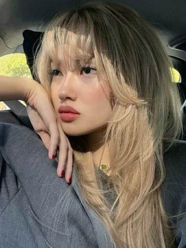 Try on this stylish layered haircut with sweeping bangs, giving a casual and modern vibe.