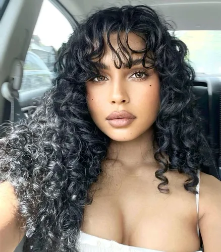 Try on this voluminous long curly hairstyle evident in the photo